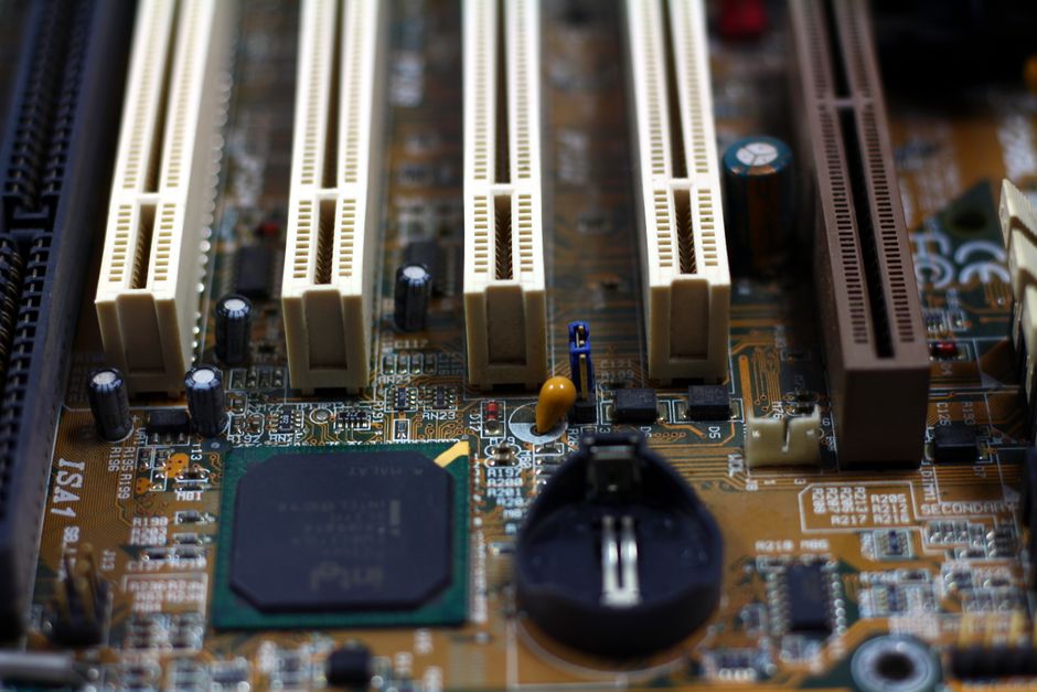 Detailed close-up of computer motherboard showing components like RAM slots and capacitors.